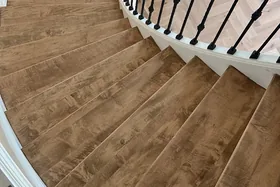 Curved staircase with warm brown treads